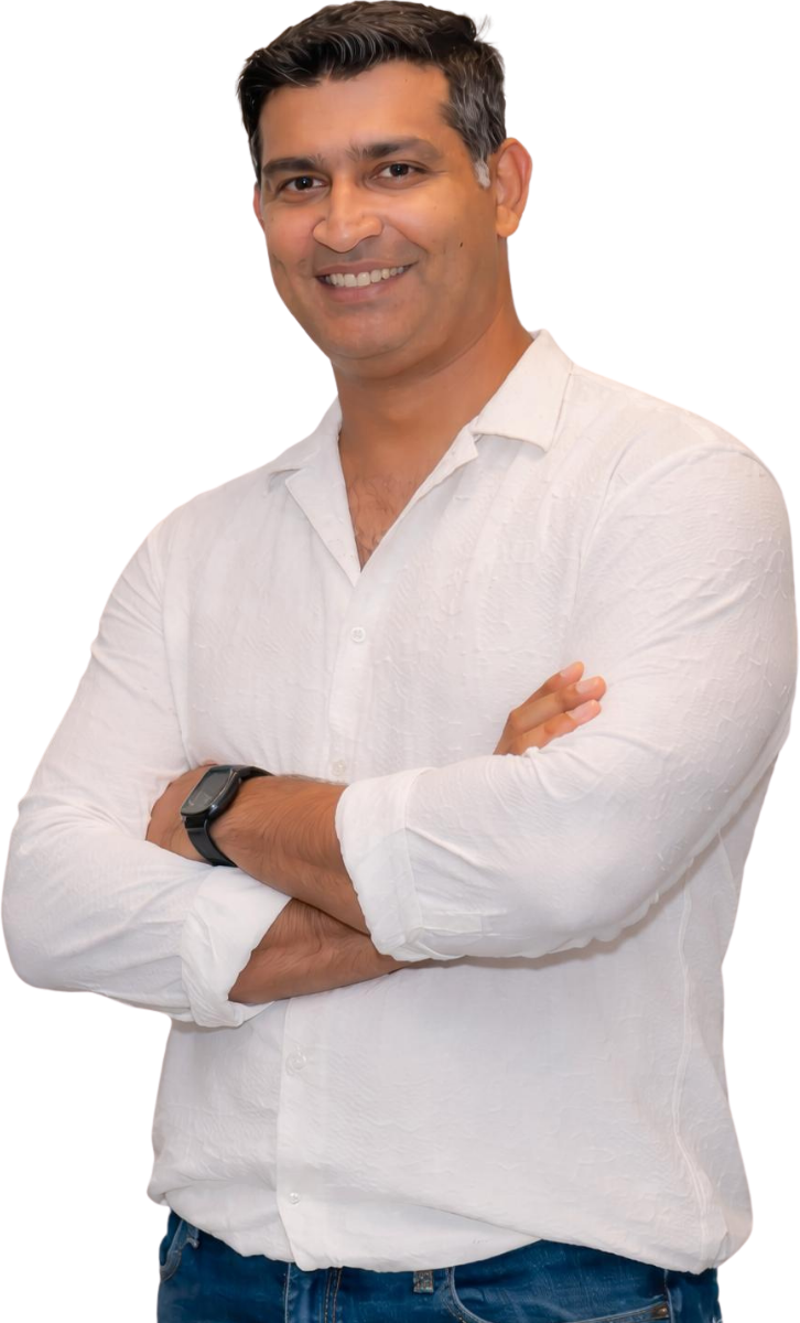 Rounak Jaggi, Director of Operations and Marketing at AIM Cricket Academy, smiling in a white shirt
